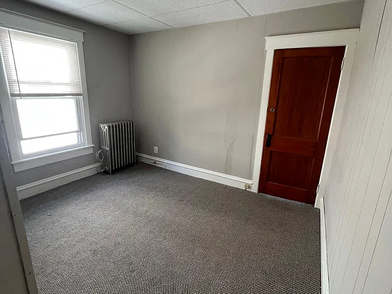Living room showing door closed to bedroom