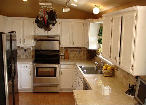stainless steel appliances, granite tile counters, tumbled stone backsplash