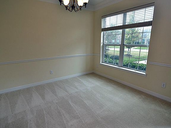 The dining room is accented with chair railand a great view of the front yard.