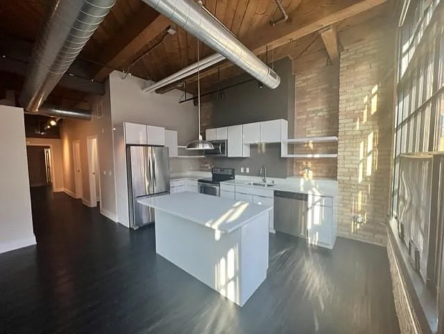 213 Broadway offers high end stainless steel appliances including a dishwasher, microwave, electric glass top range, and oversized refrigerator with filtered water and ice maker.
