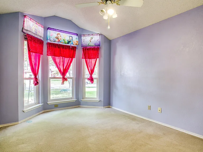 Bedroom 1 faces the front of home. 3 large bay windows. Ceiling fan too.