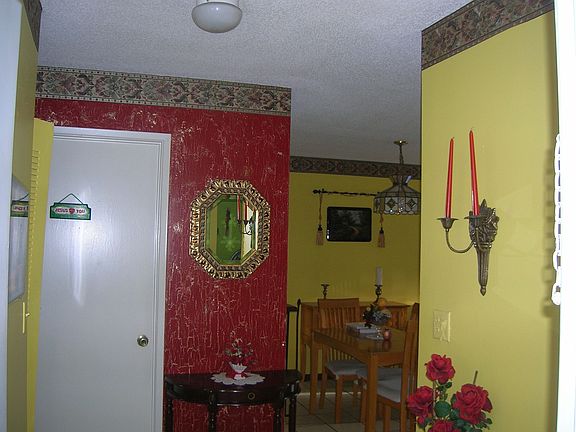 view from entrance hallway to  bathroom door and dining room