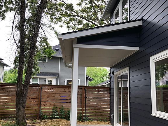 Covered porch adjoining the kitchen-dining area. space for outdoor lounging or dining.