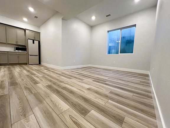 Spacious living room with a large egress window