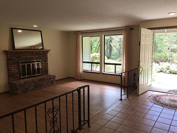 Sunken living room with wood burning fireplace