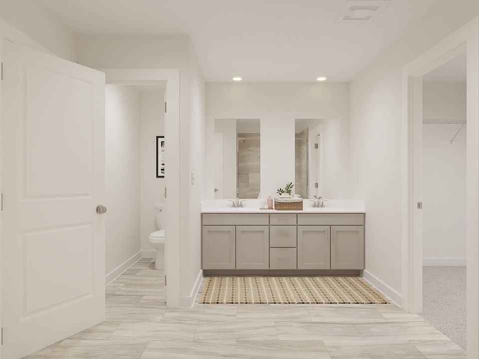 The primary bathroom offers dual vanity sinks and a walk 8212 in shower.