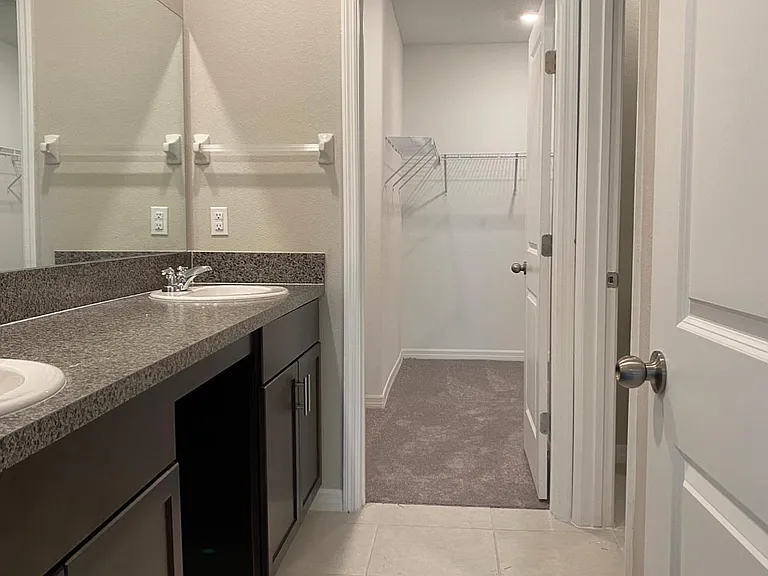 Master suite offers double vanity and large walk in closet