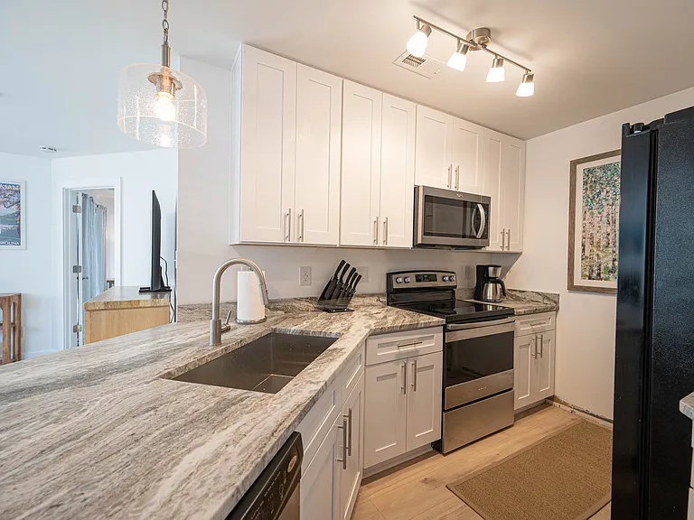 Kitchen w/ D/W, garbage disposal, refrigerator, stove, microwave and stocked with toaster, coffee maker, dishes, etc.