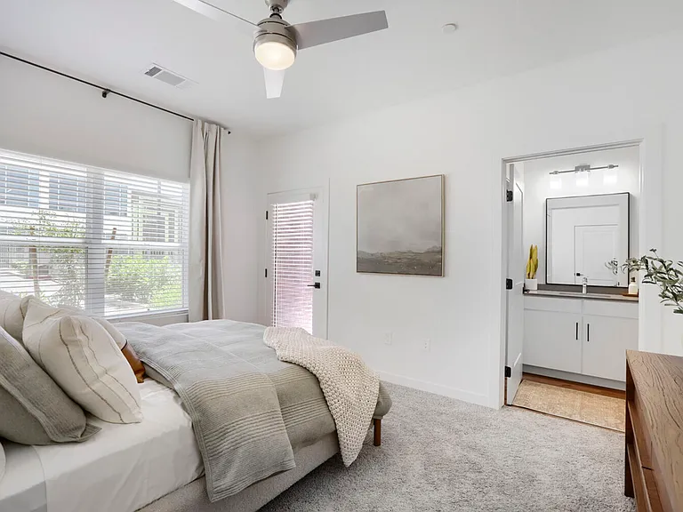Enjoy your personal retreat. The B2 primary bedroom features everything you need to unwind at the end of the day, including plush carpet, generous natural light, a ceiling fan, and a private en suite.