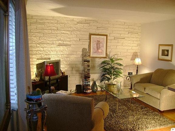 Living room with stone wall