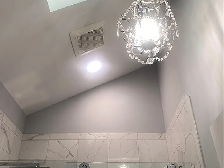 High ceiling with skylights and high end chandlier.