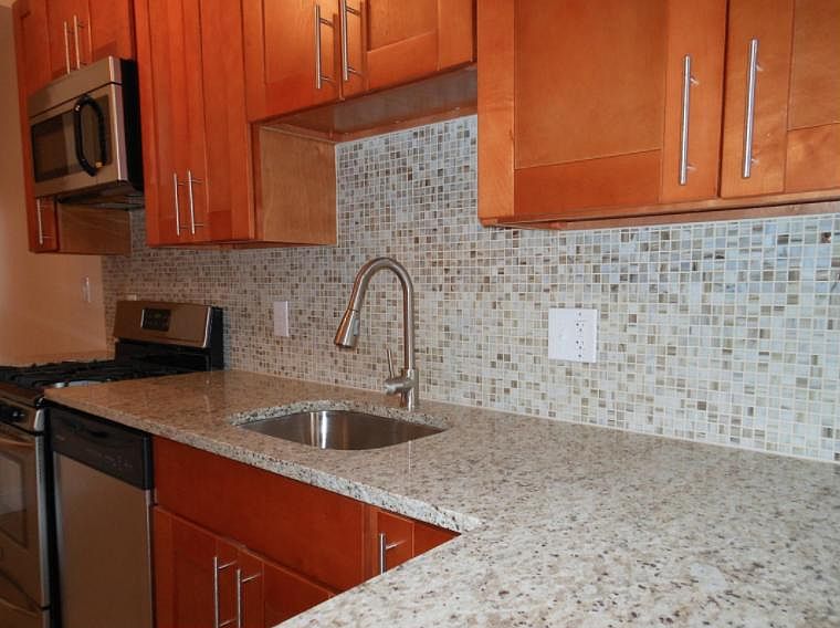 Kitchen detail: undermount sink, granite counter, glass tile