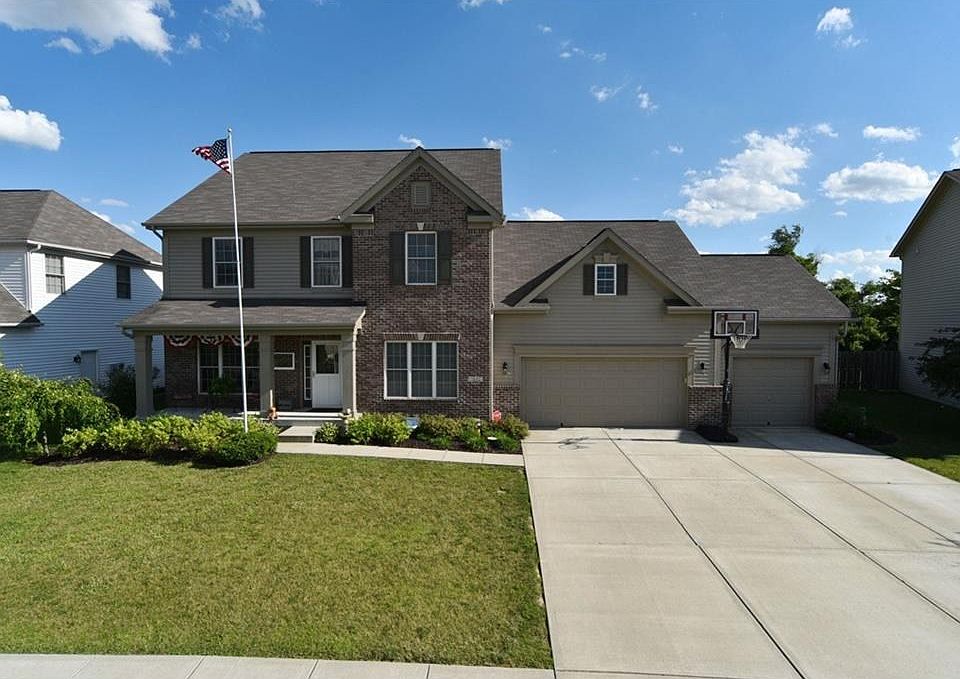 Nicely landscaped, with covered front porch.  The best part?  A 4-car garage!  (the 4th car stall is tandem behind the 2-car stall)