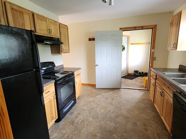 Kitchen showing shared entrance to cellar and front of duplex.