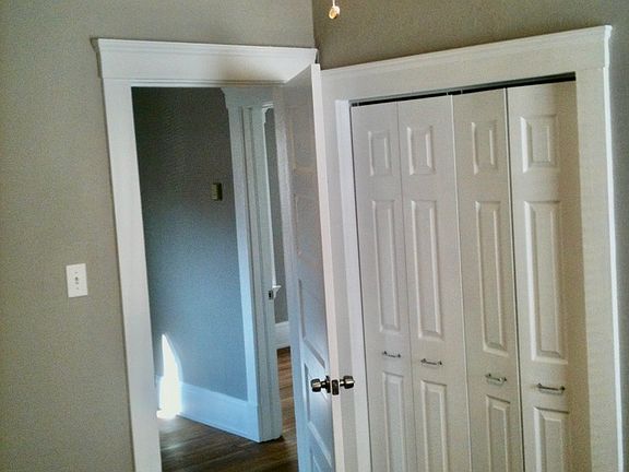 Inside main bedroom w/ closet and view in to living room