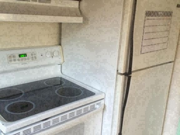 Kitchen With Full Size appliances Flat top stove