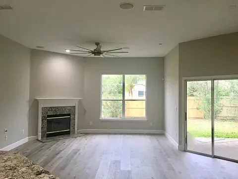 Living room with newly upgraded patio doors and 12ft ceiling throughout living space