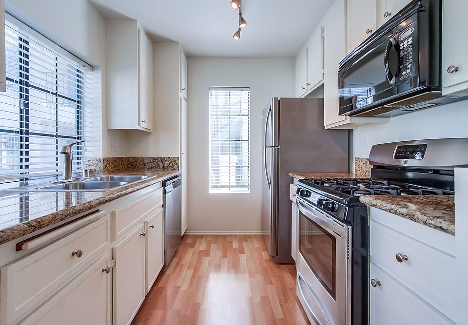 Easy use kitchen with gas oven, microwave, Refrigerator and dishwasher with lots of cabinetry and light.