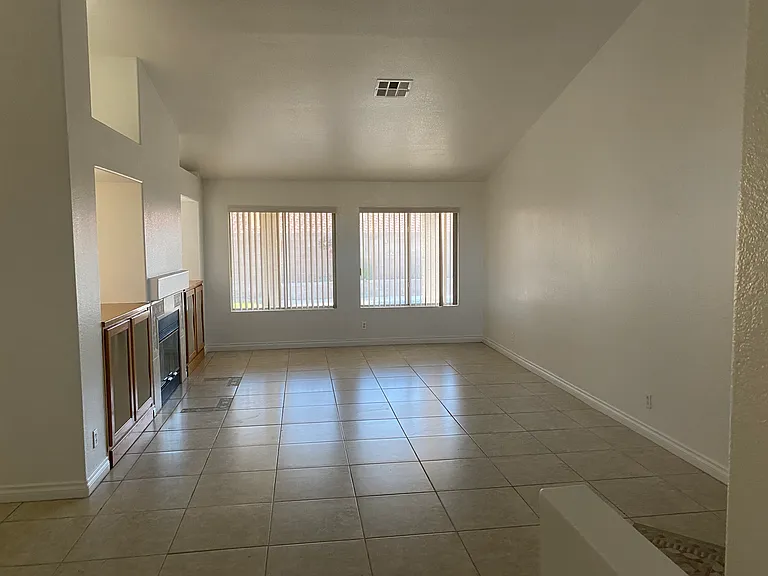 Living room - From the front double-door entry to the home. Fits furniture or a pool table great. Dual-side fireplace, great view of vaulted ceilings and pool as you walk in. To the left is the family room and kitchen and to the right are the bedrooms.