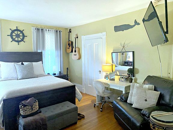 Bedroom with 3 windows and original marble fireplace! Bedroom has 2 closets.