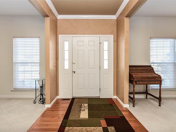 Entry foyer with hardwood flooring, crown molding and 9' ceilings.