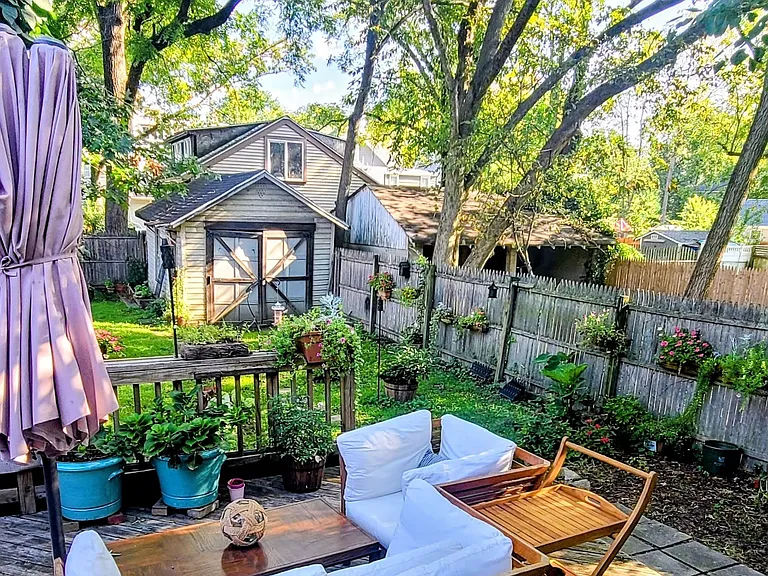 Double-tiered deck and fenced backyard