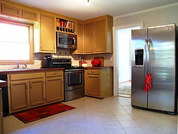 Kitchen is updated with newer stainless appliances, 5 burner electric & convection range, built in microwave and room for an island!