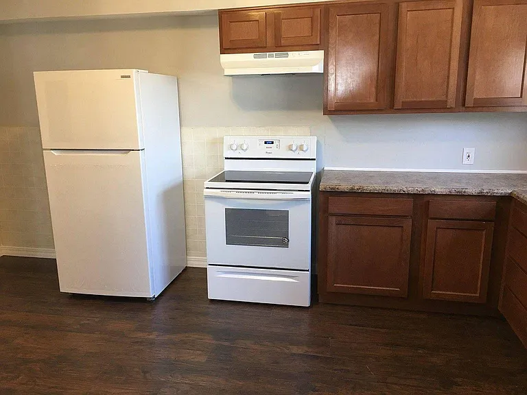 Newly renovated kitchen with all new appliances (refrigerator, electric oven/stove, dishwasher, countertop, cabinets, sink, and floor)