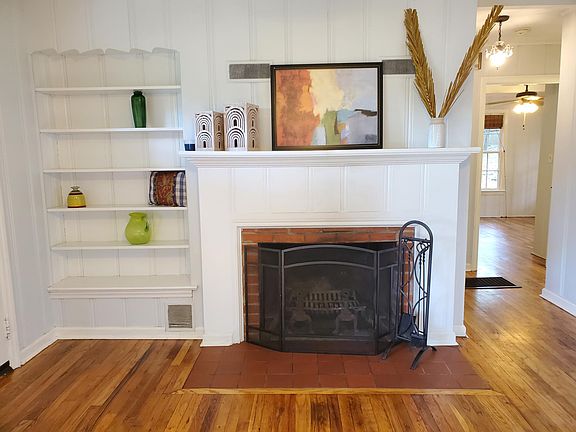 Wood-burning fireplace, mantle, and built-in bookshelves