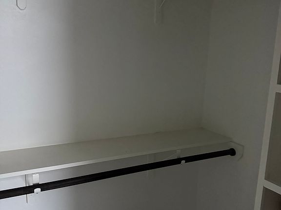 closets with dark stain rod holders