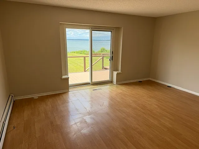 Another view of primary bedroom and sliding door to deck