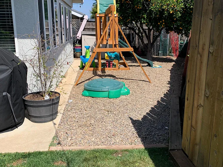 Side of backyard. Swing set negotiable.