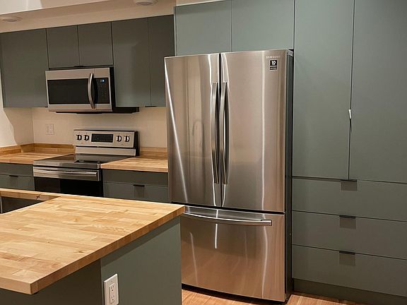 Ample kitchen storage including a pantry.