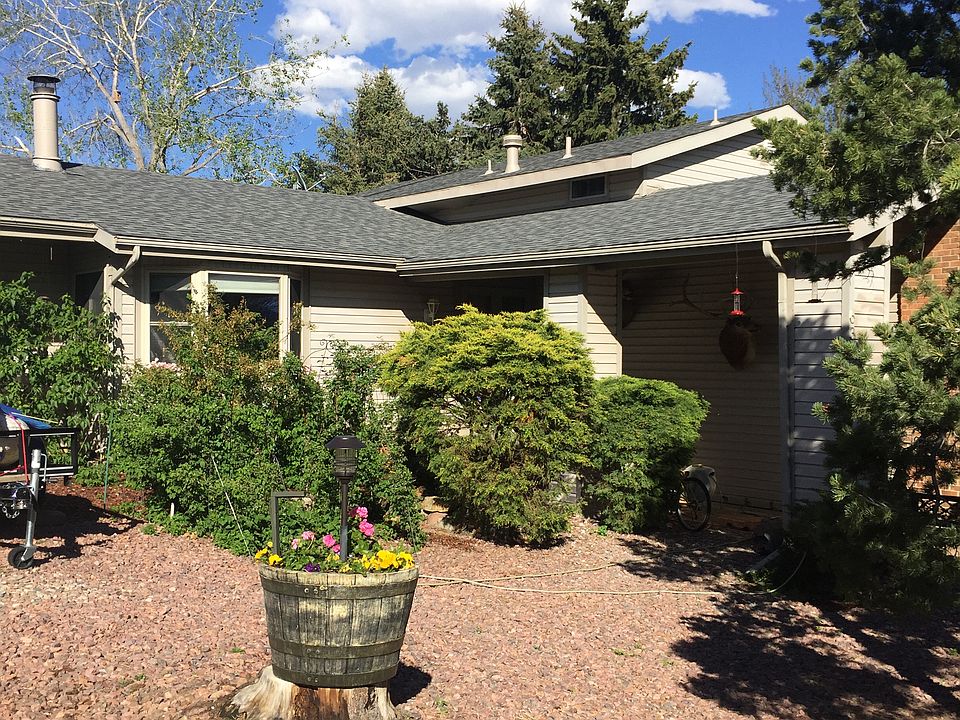 Front of home with picture window facing mountain