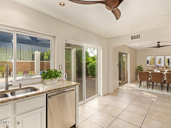 beautiful kitchen with attached dining room and ample sunlight and fans. Great for entertaining.