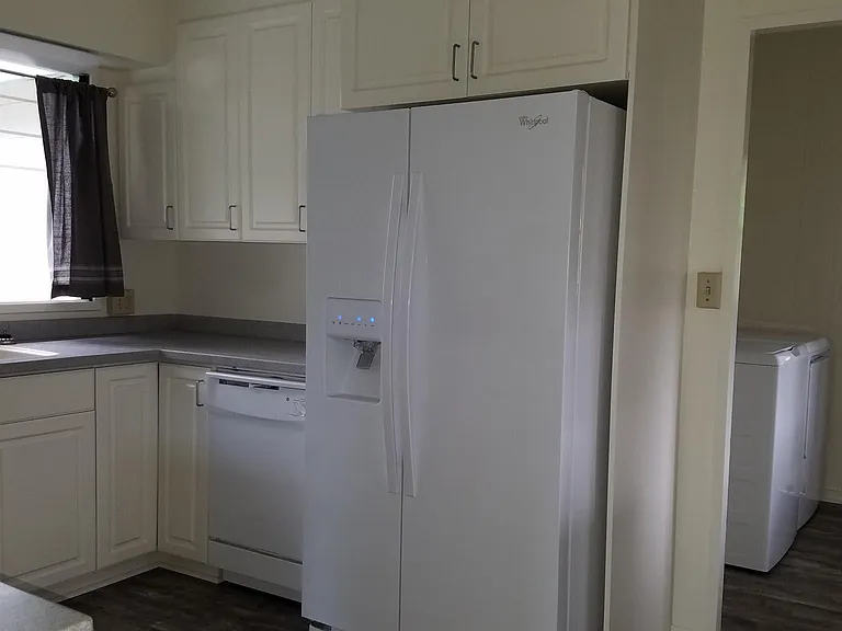 Kitchen with adjacent laundry area.