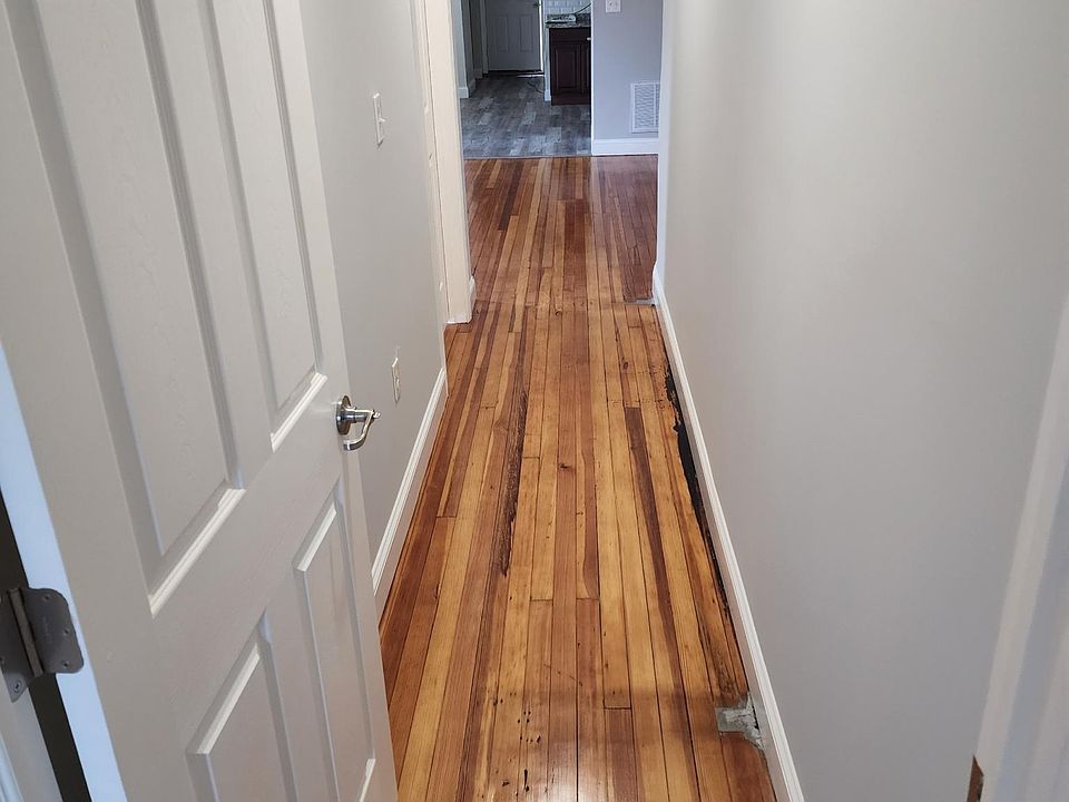 Hallway with fresh polyurethane wood floors.