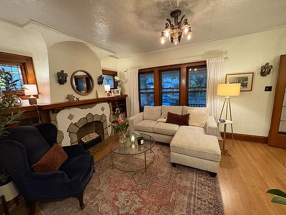Original Art Deco light fixtures; bookcases flanking fireplace with stained glass doors, leaded glass French doors lead to sunroom