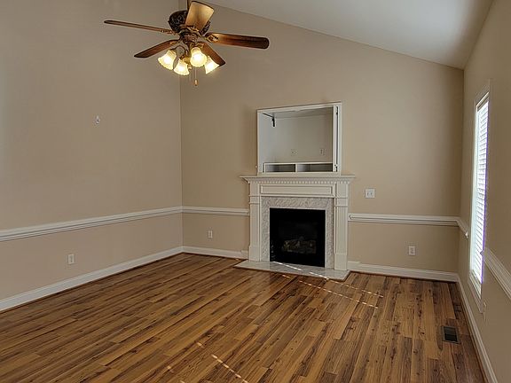 Family room with built in tv area with pocket doors above fireplace