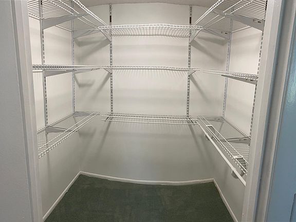 A spacious walk-in closet. in the master bedroom is functional and has plenty of room