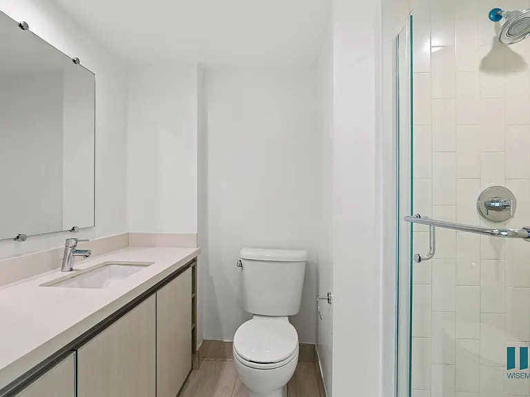Bathroom with Stand-Up Shower with Glass Door and Vanity Cabinet Storage
