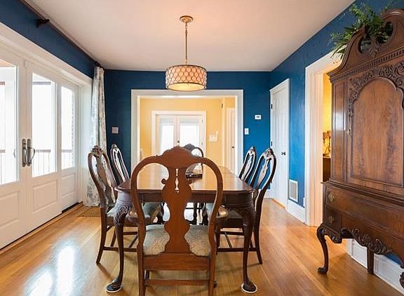 Gracious Dining Room - ideal flow for entertaining. Glass inlaid doors open to the screened-in porch.