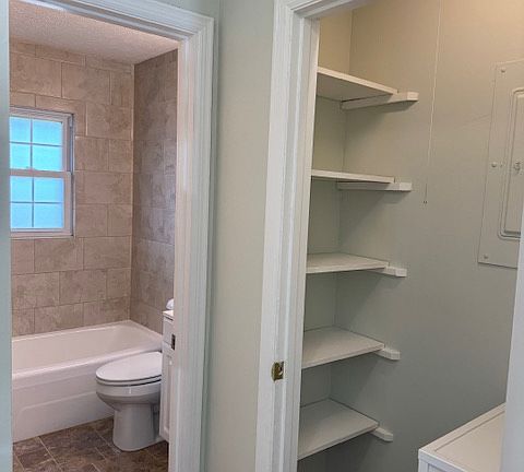 Linen closet in hallway. 
Bathroom with new tile surround.
Vanity just out of sight.