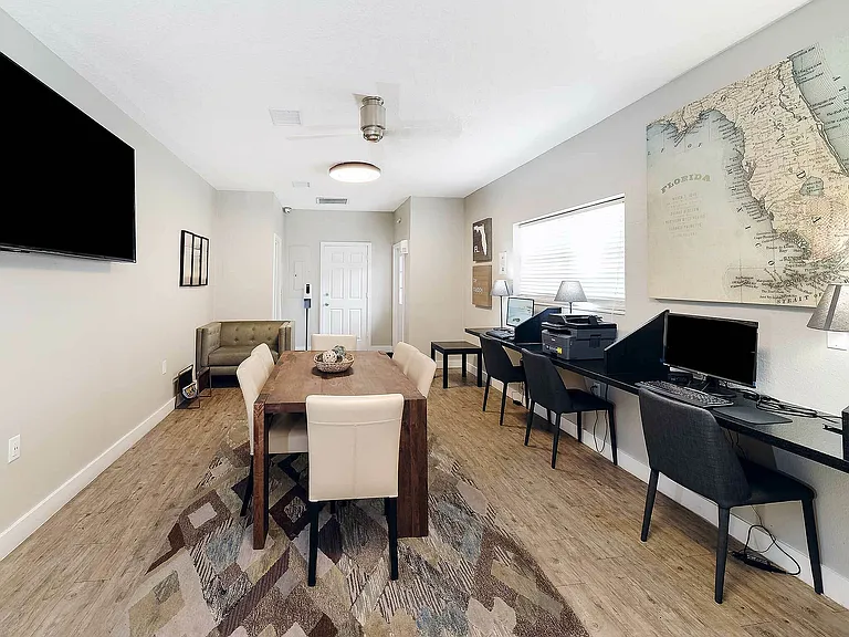 Experience this modern living space with a perfect blend of work and dining areas.