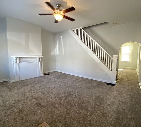Large, bright living room with fresh paint and new carpeting