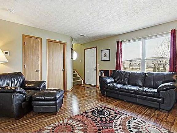 Sunny great room with pond view and neutral decor.