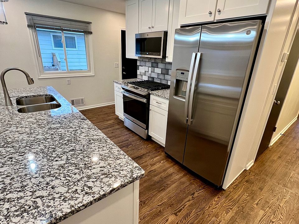 Kitchen. Refrigerator has cold water and ice dispenser. There is a pantry to the right of the refrigerator. It's the door on the right edge of the photo.