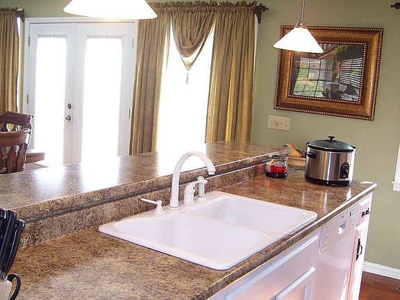 Kitchen open to dining room with bar for casual dining