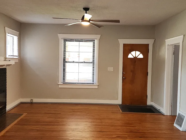 View from dining room to the front entry showing the fireplace.