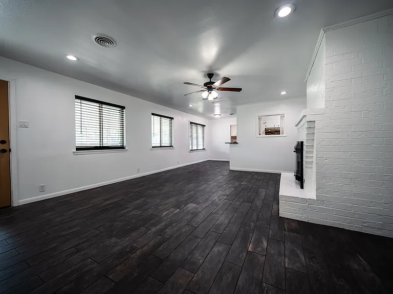 Open-concept living and kitchen area with recessed lighting and ceiling fans